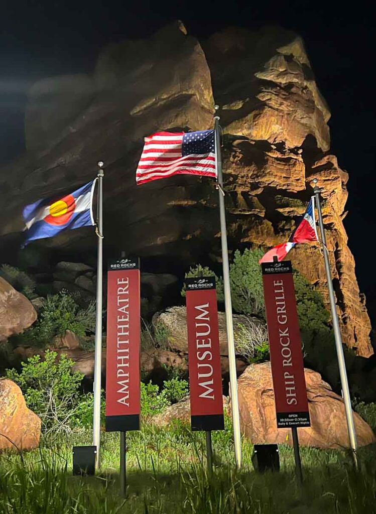 flags in front of red rocks amphitheater am