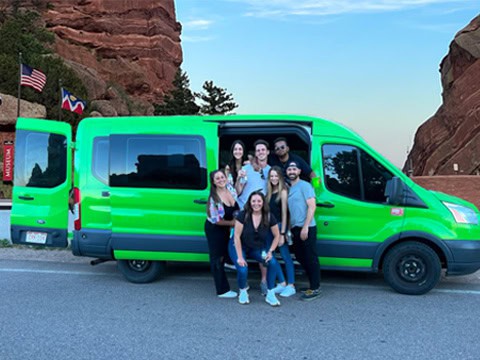 group going to red rocks standing in front of shuttle